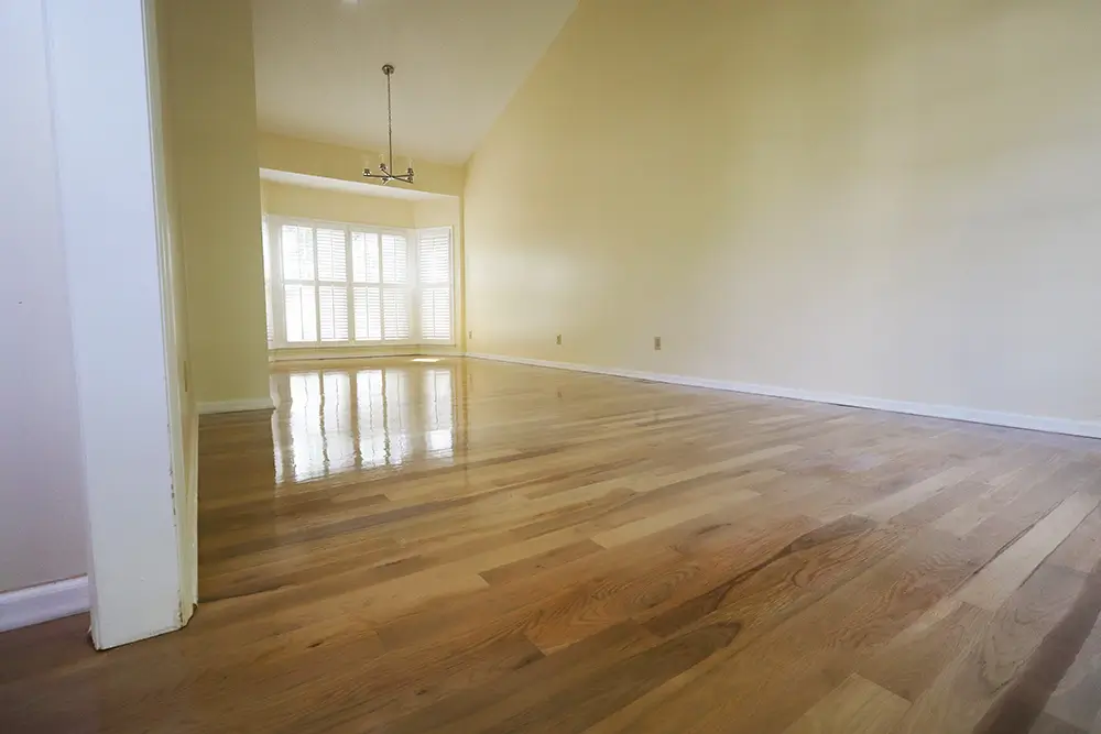 Sanded hardwood floors during refinishing process in Raleigh