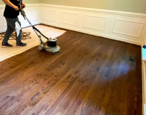 Hardwood floor sanding during refinishing process in Morrisville NC home